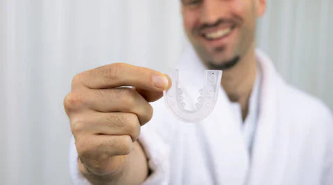 Close-up image of a custom-fit dental guard designed to reduce snoring by gently repositioning the jaw, improving airflow for a more restful night's sleep